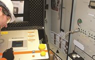 A man checking for impurities and issues in switchgear